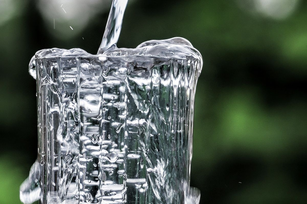 Clean filtered water pouring into a glass for hydration
